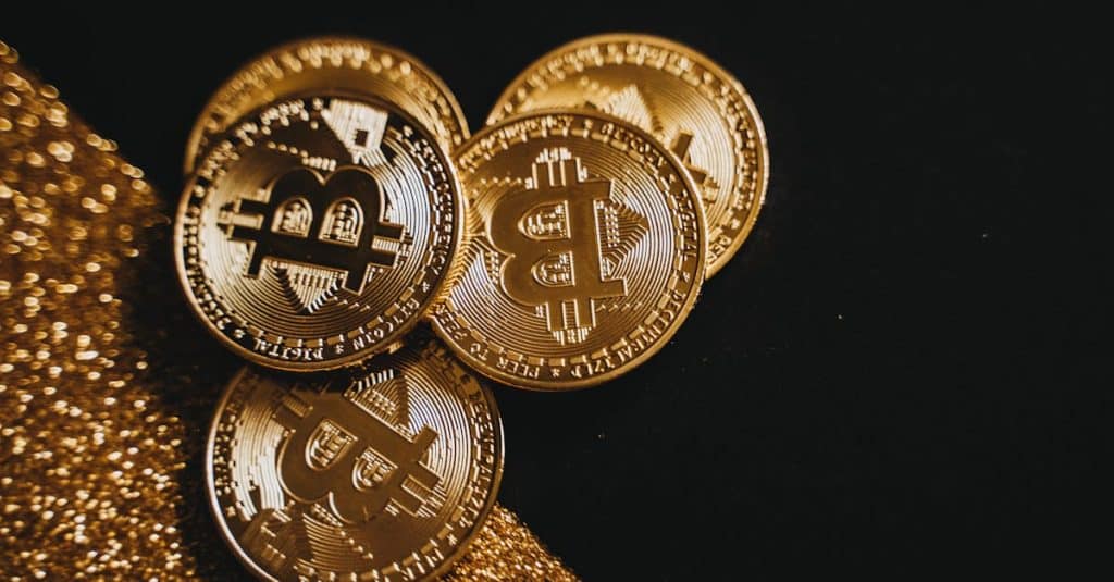 Melina Trump Token: The Viral Crypto Sensation Explained 8 a-detailed-close-up-shot-of-shiny-bitcoin-coins-resting-on-a-glittery-surface-symbolizing-wealth-in