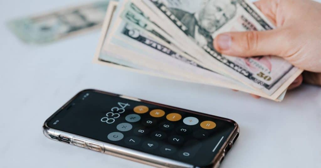 Cash App Borrow: Get Quick Loans in Minutes Instantly 5 calculator-application-on-mobile-phone-screen-on-white-surface-near-crop-anonymous-person-holding-pi