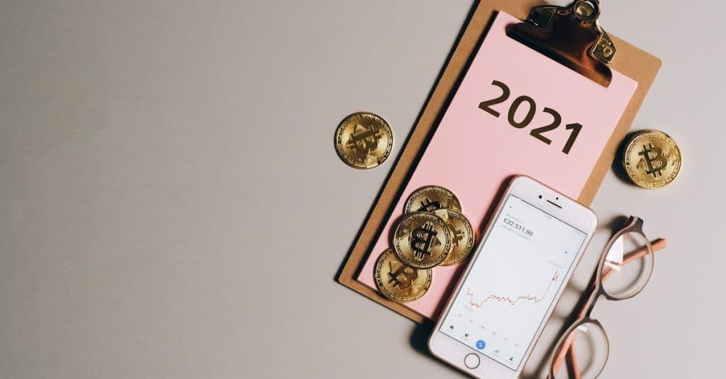 Melina Trump Token: Shocking Price Predictions Unveiled 10 flat-lay-of-bitcoins-smartphone-eyeglasses-and-clipboard-with-2021-text-symbolizing-cryptocurren
