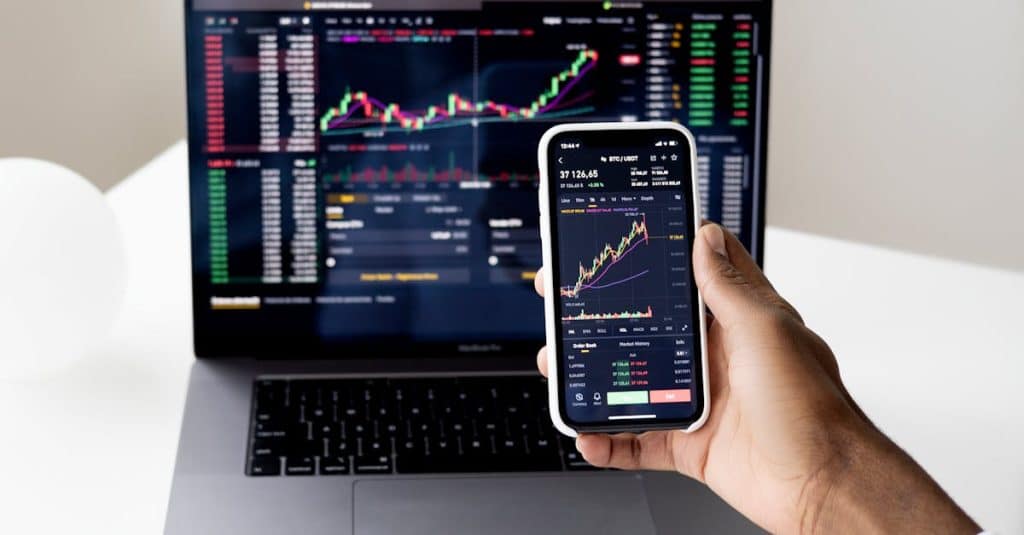 Alephium Price: Unveiling the Crypto Gem's Market Potential 3 person-checking-stock-market-graphs-on-laptop-and-smartphone-focusing-on-financial-data